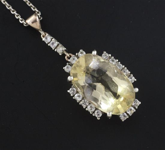 A gold, citrine and gem set oval pendant, pendant 1.75in.